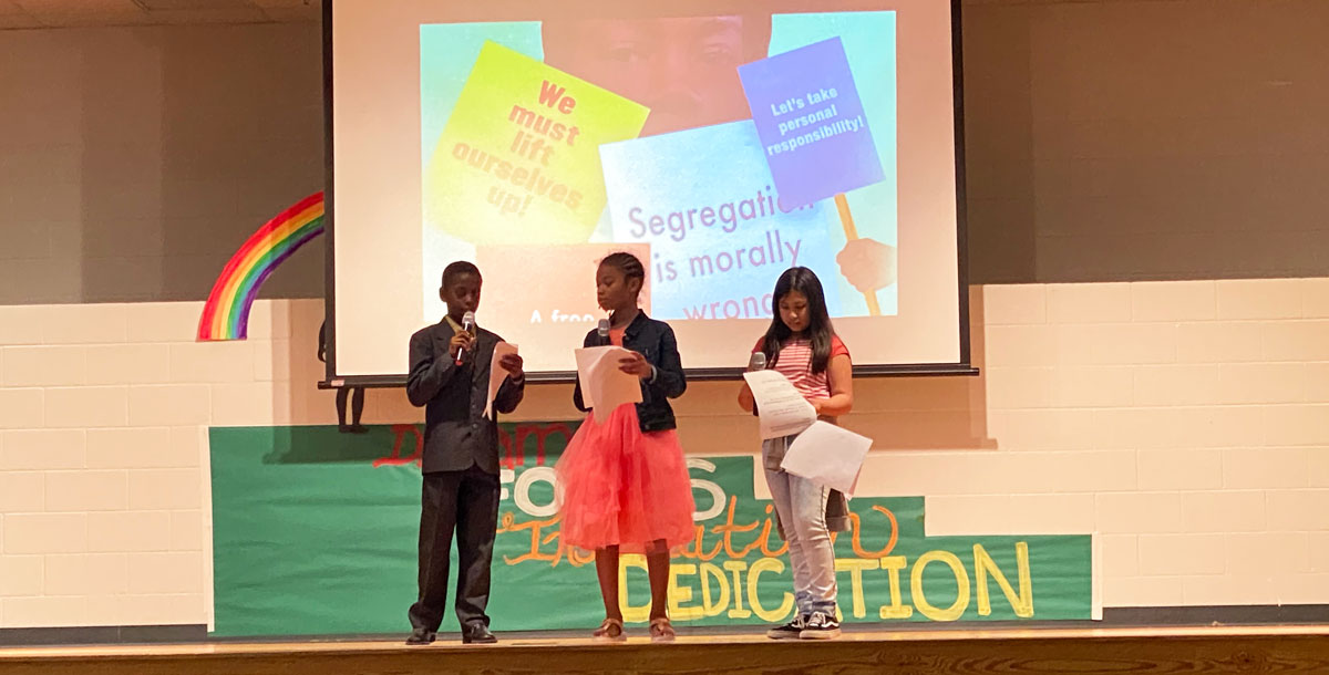 Fifth-graders Benjamin Wells, Zoe Wilson and Samantha Gomez-Licon perform their skit for the Academy students.