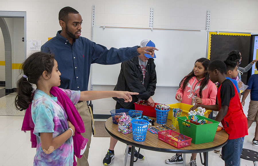 Darron Daniels supervises students at the Appalachian Academy at Middle Fork as they redeem positive behavior tokens for school supplies and treats. Photo submitted