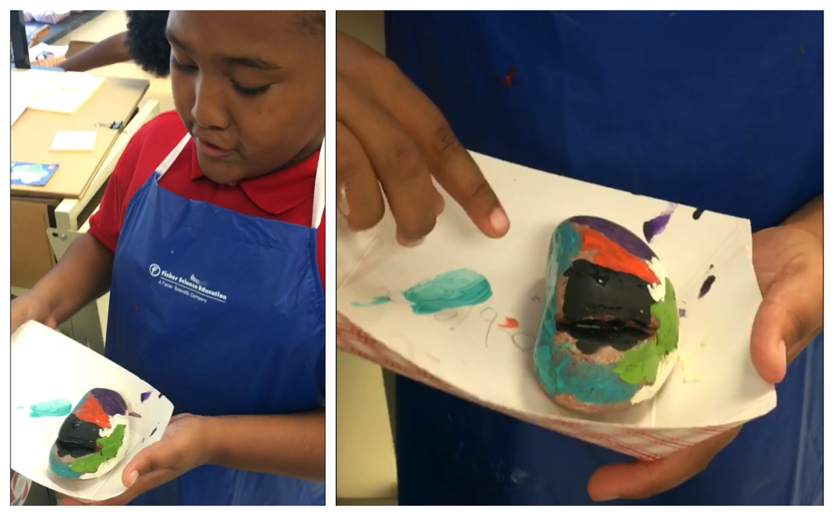 Academy third grader, Delande Hawkins, explains the meaning of the colors he selected for his identity rock. Photo submitted