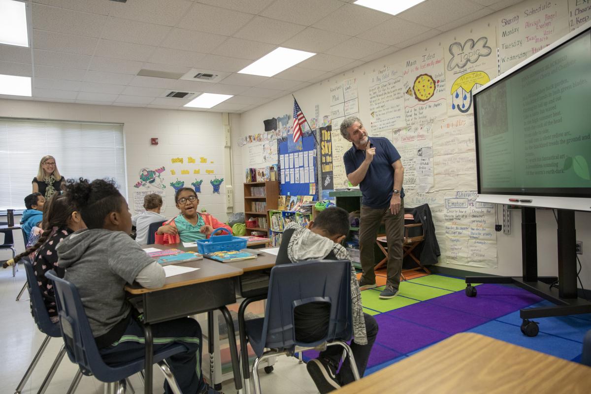 Rice (center) and Frye (left) engage with students in Suzanne Smith’s third-grade classroom at the Academy at Middle Fork. Photo by Troy Tuttle