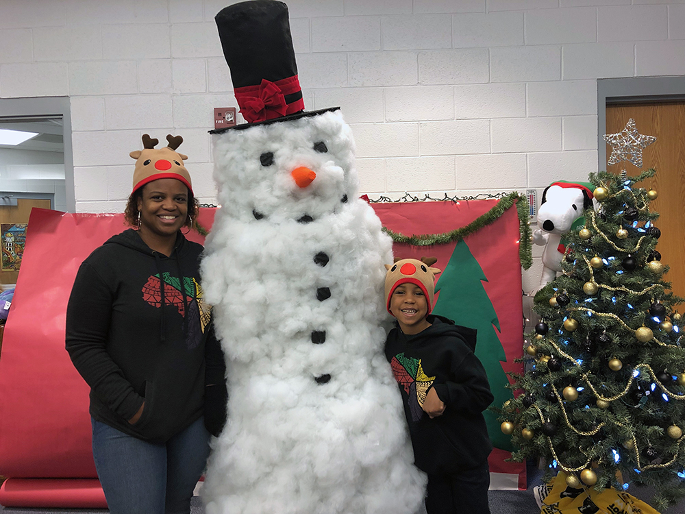 ESL teacher, parent and Appalachian reading education master's candidate, Chantae Reynolds, and her son, Jameson Kankula, pose for a picture with the Academy's very own Frosty (aka Physical Education teacher, Coach Phelps, who made the costume herself). Photo submitted